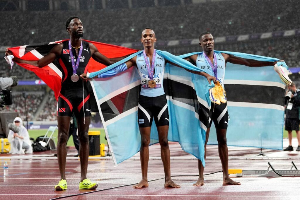TT runner Jereem Richards, left, after winning silver in the 400m event at the World Championships. AP PHOTO - (Image obtained at newsday.co.tt)